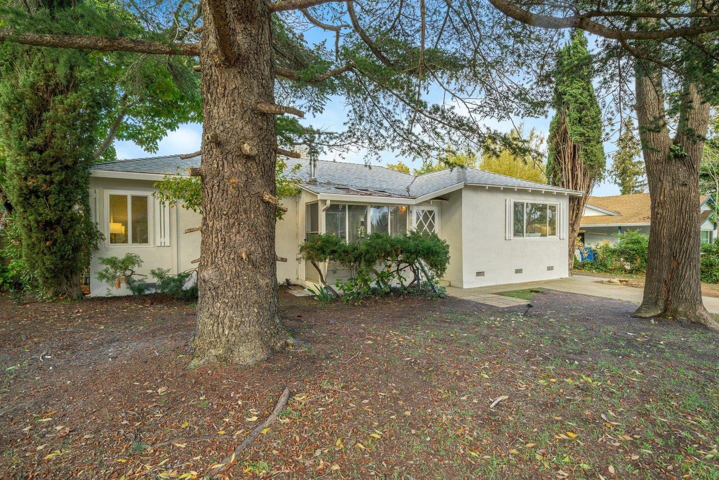 a view of a house with a tree in front