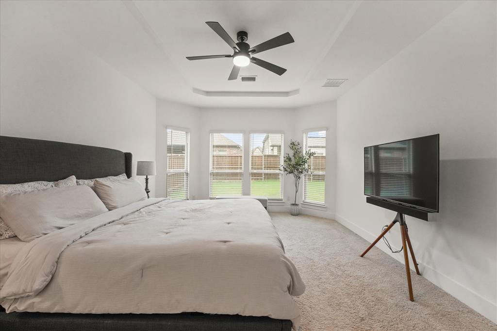 1714 Highwood Road Forney, TX 75126 - Photo 30 of 30 a bedroom with a bed and a flat screen tv
