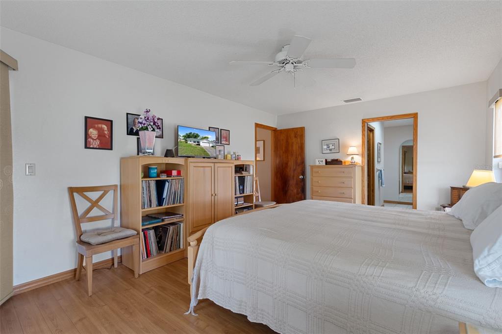 5035 Harbinger Road Spring Hill, FL 34608 - Photo 33 of 47 a bedroom with a bed and a bookshelf