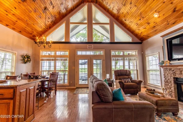 a living room with fireplace furniture and a floor to ceiling window