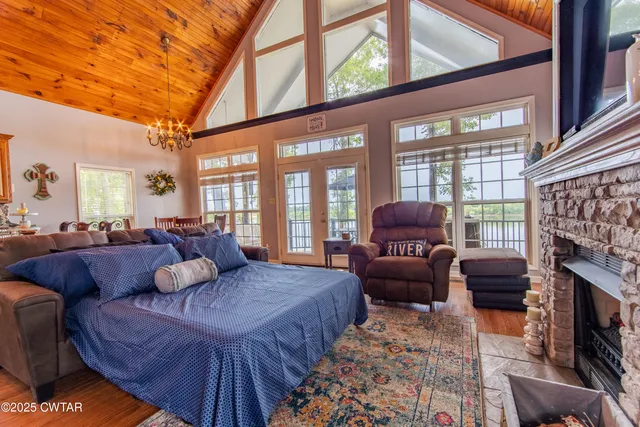 a living room with furniture a fireplace and a large window
