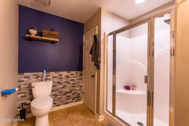 a view of a hallway with wooden floor and closet