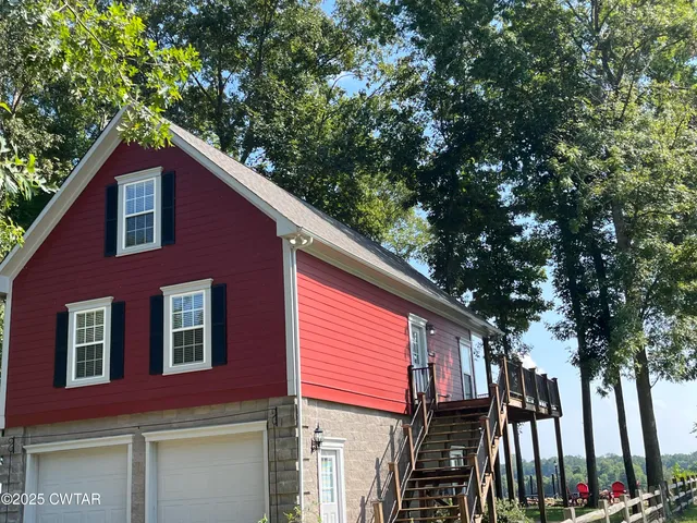 a house view with a tree in front of it