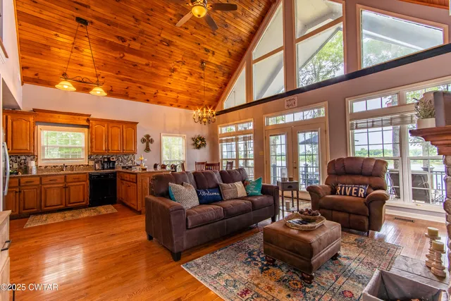 a living room with furniture and a kitchen view