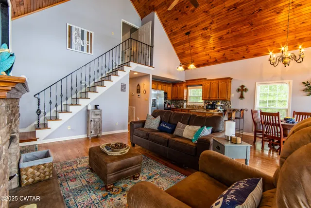 a living room with furniture and a chandelier