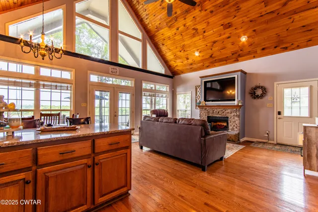 a living room with furniture a flat screen tv and a fireplace