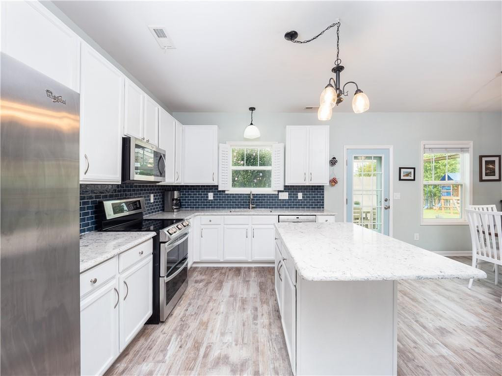 306 Green Pasture Road Mebane, NC 27302 - Photo 11 of 35 a large kitchen with cabinets wooden floor and stainless steel appliances