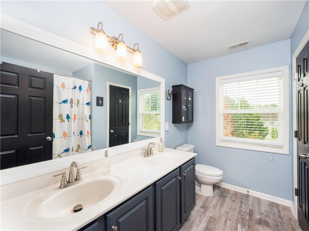 306 Green Pasture Road Mebane, NC 27302 - Photo 18 of 35 a bathroom with a toilet sink double vanity shower and a mirror