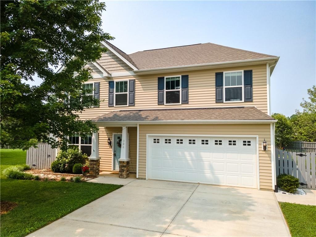 306 Green Pasture Road Mebane, NC 27302 - Photo 2 of 35 a front view of a house with a yard and garage