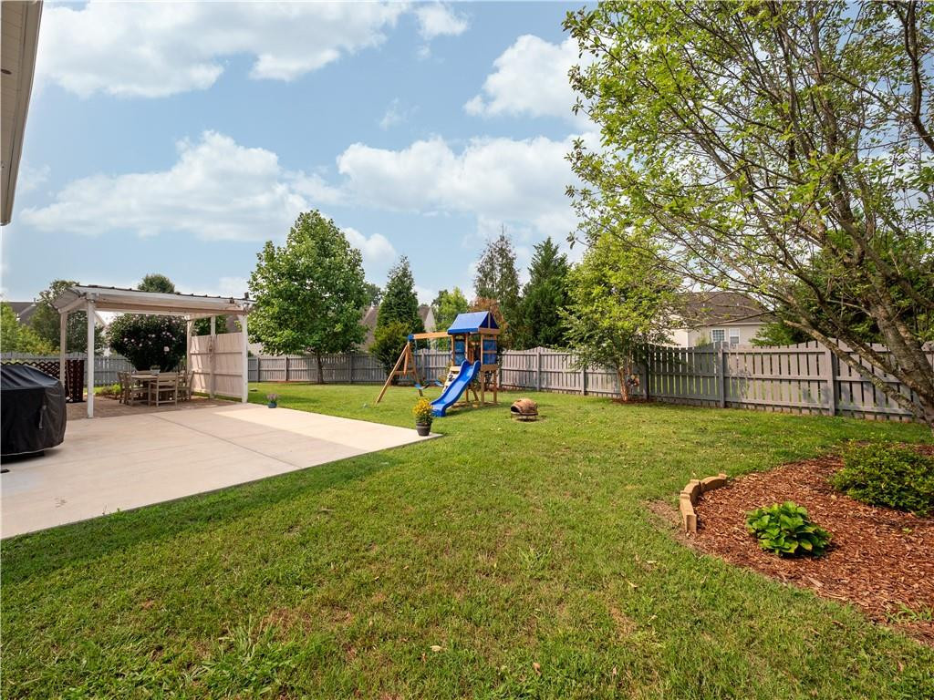 306 Green Pasture Road Mebane, NC 27302 - Photo 32 of 35 a view of a house with a backyard and a patio