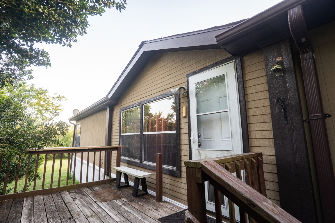 a view of backyard with deck and wooden floor