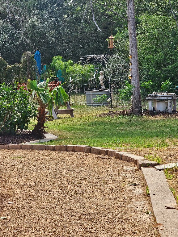 417 Hidden Oaks Drive Elgin, TX 78621 - Photo 22 of 26 a view of a backyard with large trees