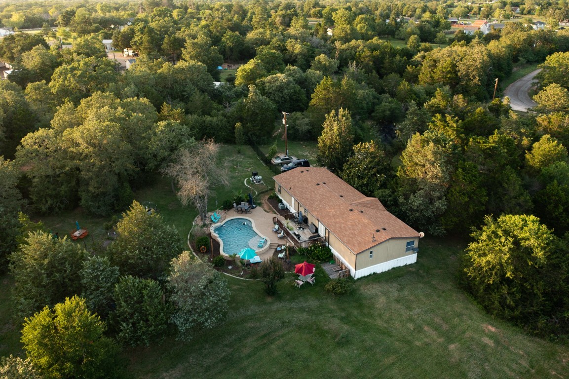 417 Hidden Oaks Drive Elgin, TX 78621 - Photo 3 of 26 an aerial view of a house with pool outdoor space and trees all around