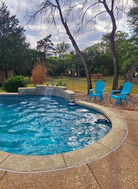 417 Hidden Oaks Drive Elgin, TX 78621 - Photo 5 of 26 a view of a swimming pool with a sitting space