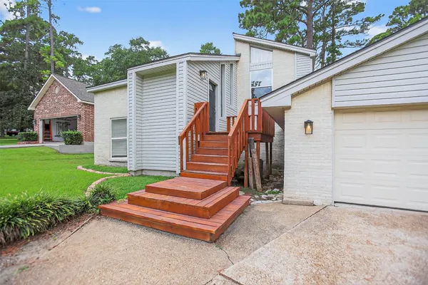 a backyard of a house with a garden and deck