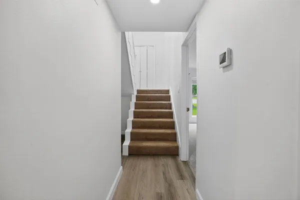a view of a hallway with stairs