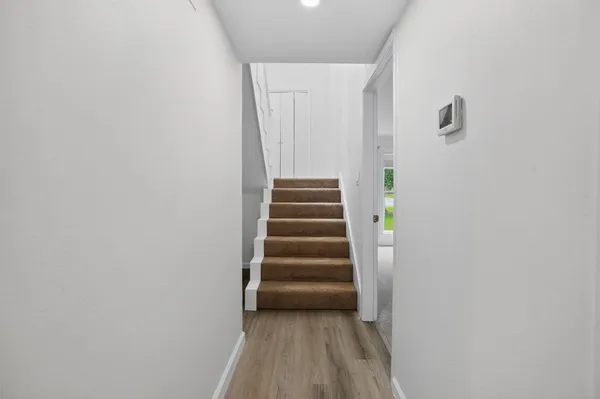 a view of a hallway with stairs