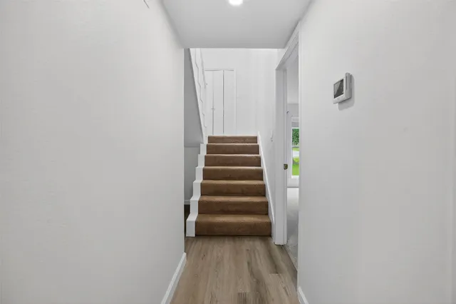 a view of a hallway with stairs