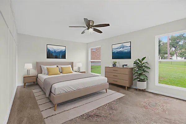 a bedroom with a bed and a potted plant