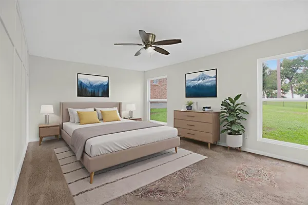 a bedroom with a bed and a potted plant