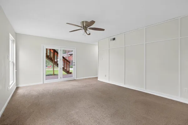 a view of a livingroom with a ceiling fan and window