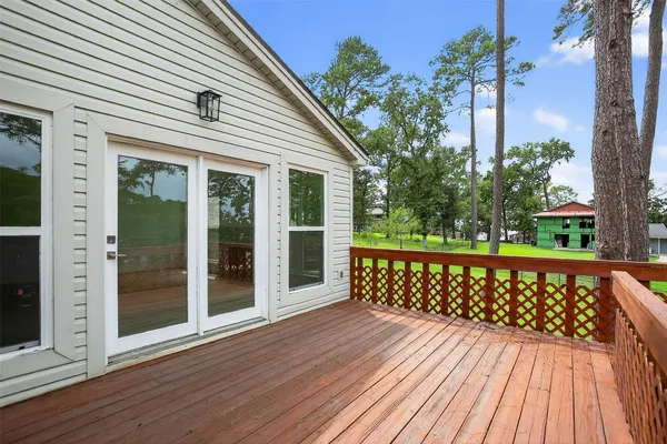 a view of a wooden deck with a yard