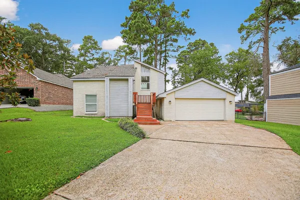 a view of garage yard and front view of a house