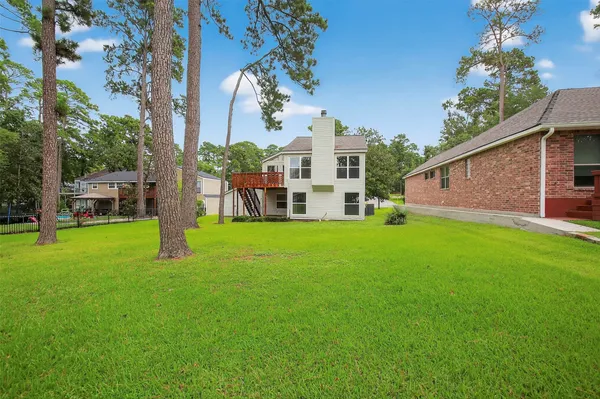 a view of a house with a yard and sitting area