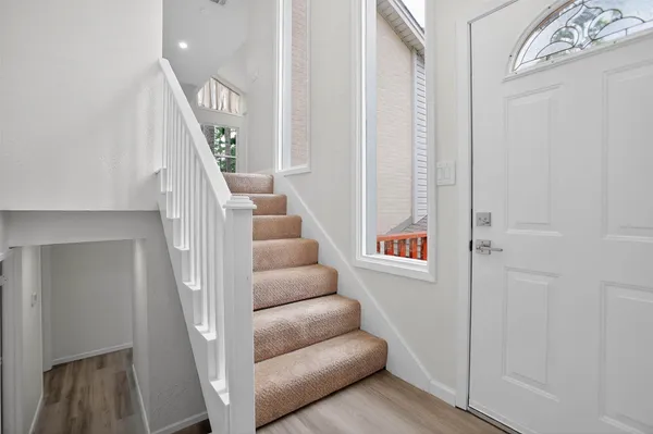 a view of entryway and hall with wooden floor