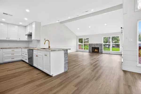 a view of kitchen with sink and wooden floor