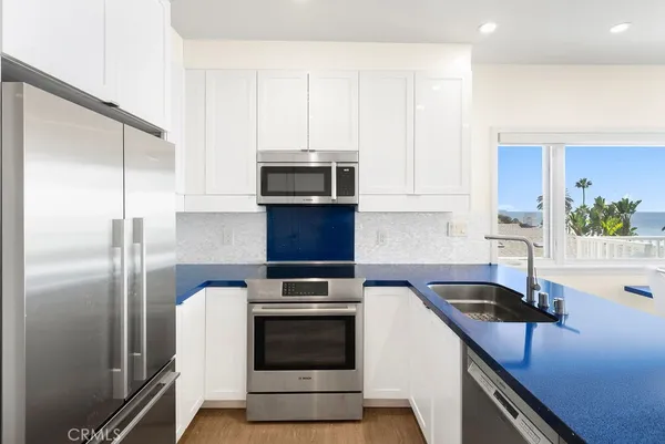 a view of a kitchen with dining room and wooden floor