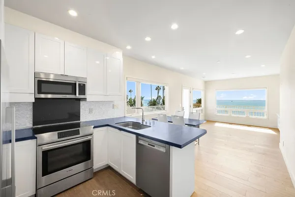 a kitchen with sink a microwave and stove