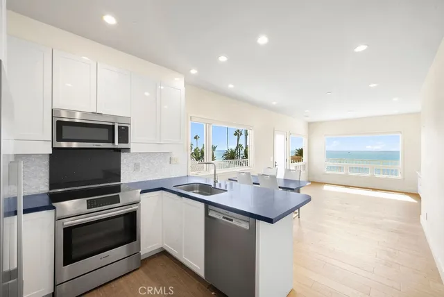a kitchen with sink a microwave and stove