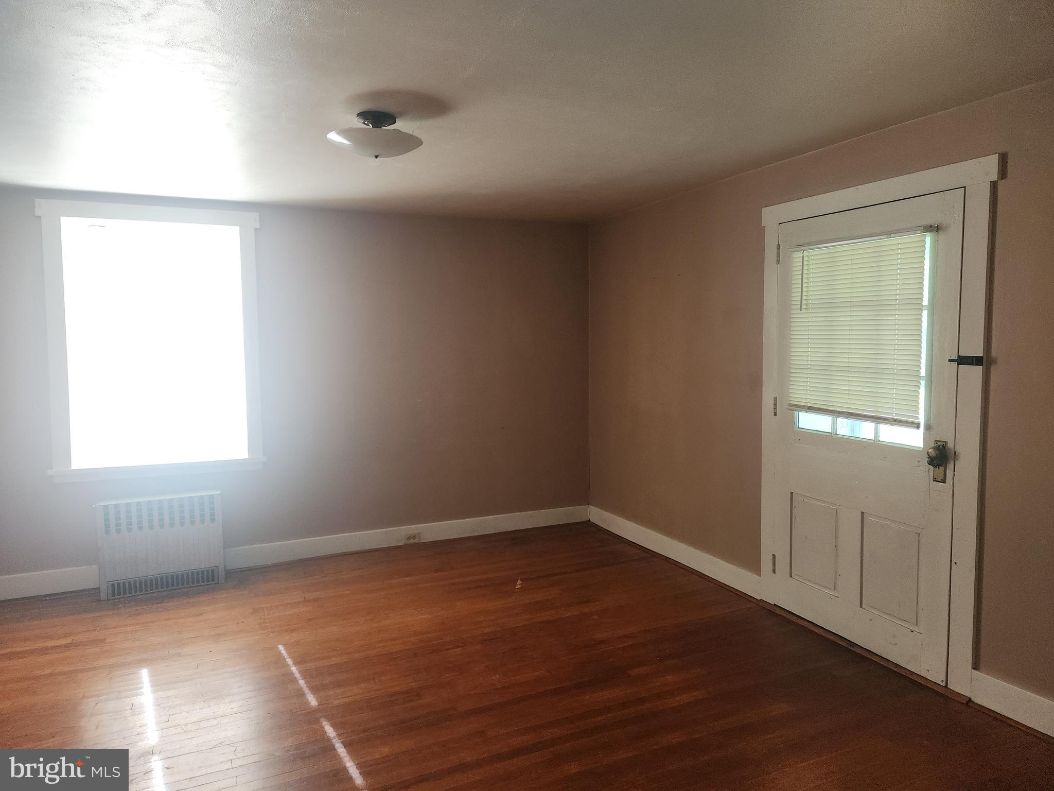 180 Range Road Mount Joy, PA 17552 - Photo 12 of 75 an empty room with wooden floor and windows
