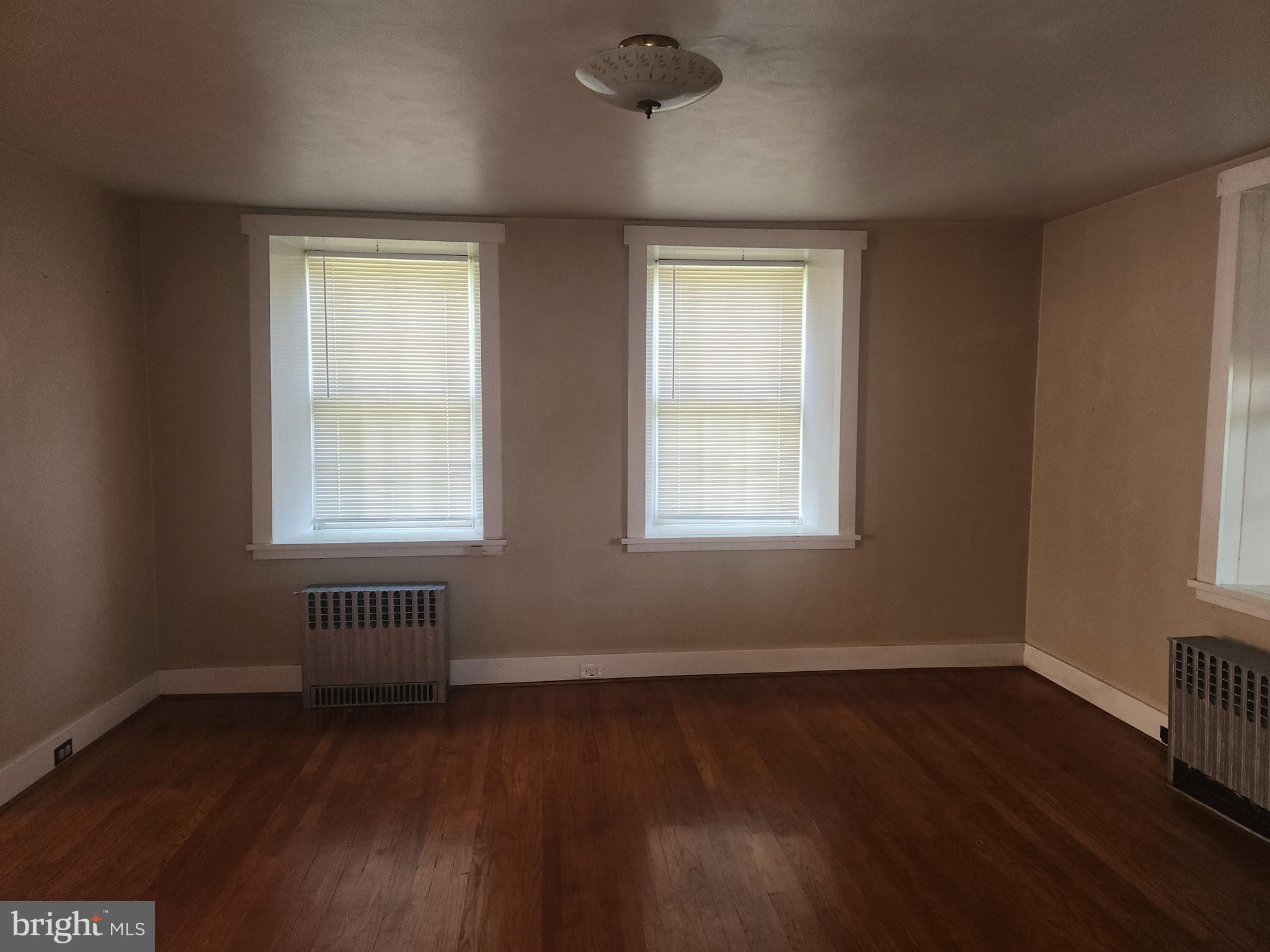 180 Range Road Mount Joy, PA 17552 - Photo 10 of 75 an empty room with wooden floor and windows