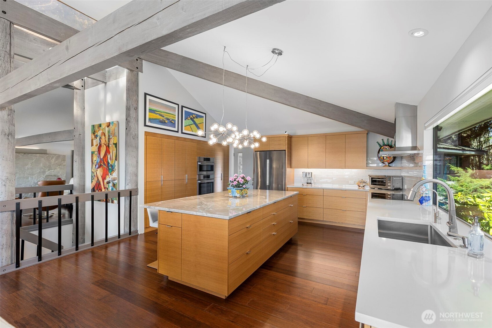 1571 Thorndyke Road Port Ludlow, WA 98365 - Photo 12 of 40 a large white kitchen with wooden floor and a sink