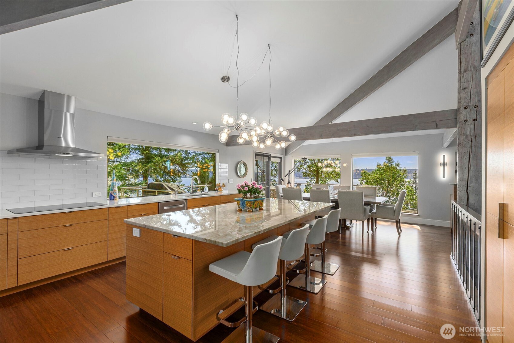 1571 Thorndyke Road Port Ludlow, WA 98365 - Photo 9 of 40 a view of a dining room with furniture a chandelier and wooden floor