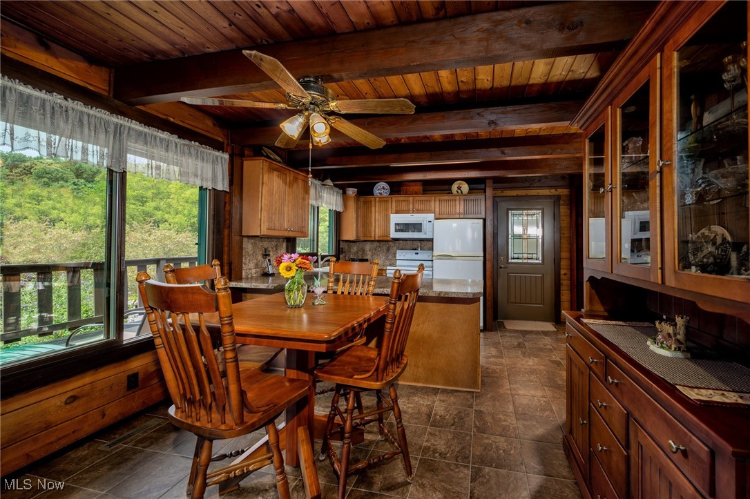 55901 Deep Run Road Martins Ferry, OH 43935 - Photo 26 of 50 Dining room with wooden ceiling, plenty of natural light, a ceiling fan, beam ceiling, and wood walls