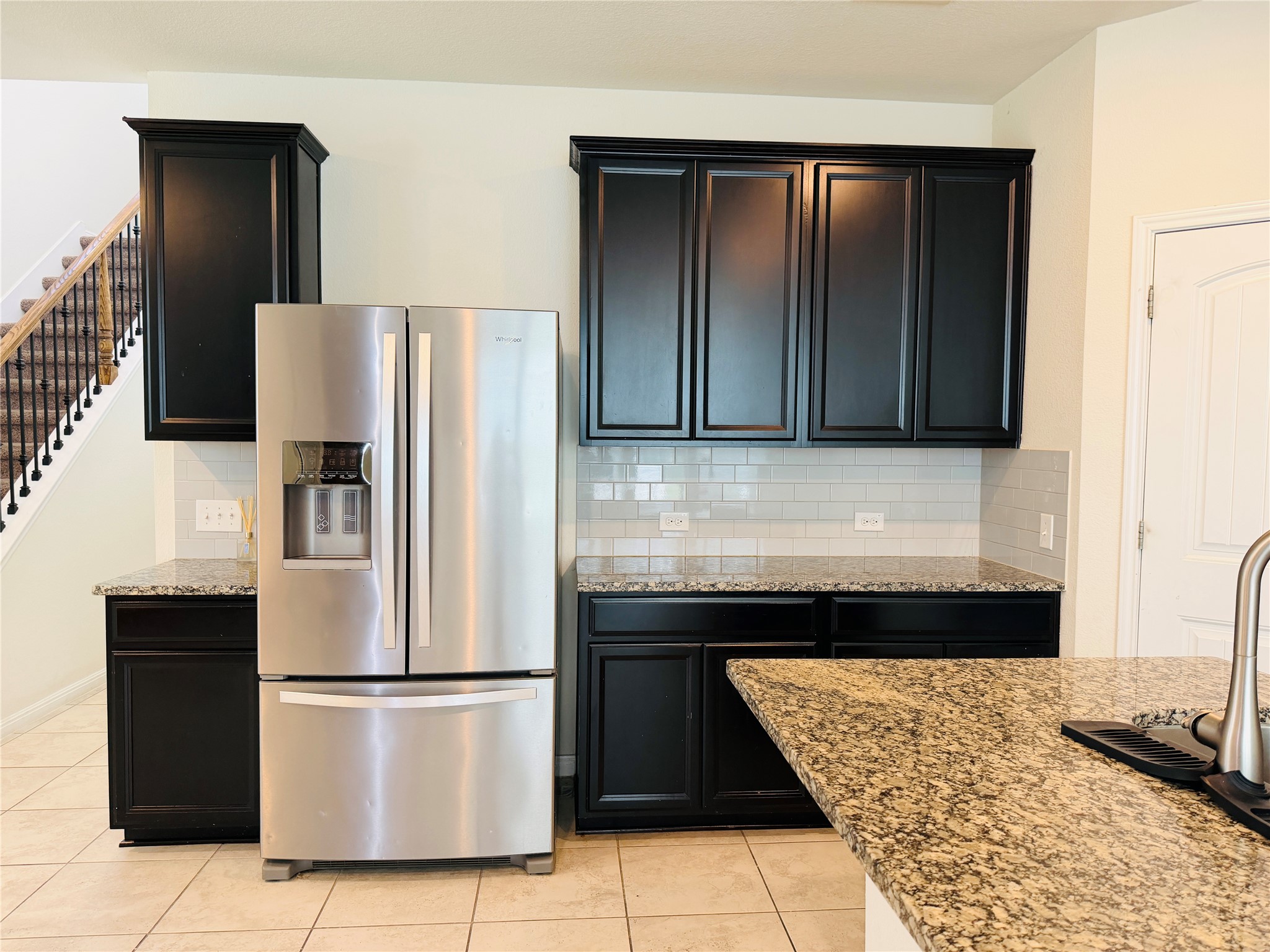 2013 Hat Bender Loop Round Rock, TX 78664 - Photo 7 of 16 Kitchen featuring stainless steel refrigerator with ice dispenser, light tile patterned floors, decorative backsplash, and light stone countertops