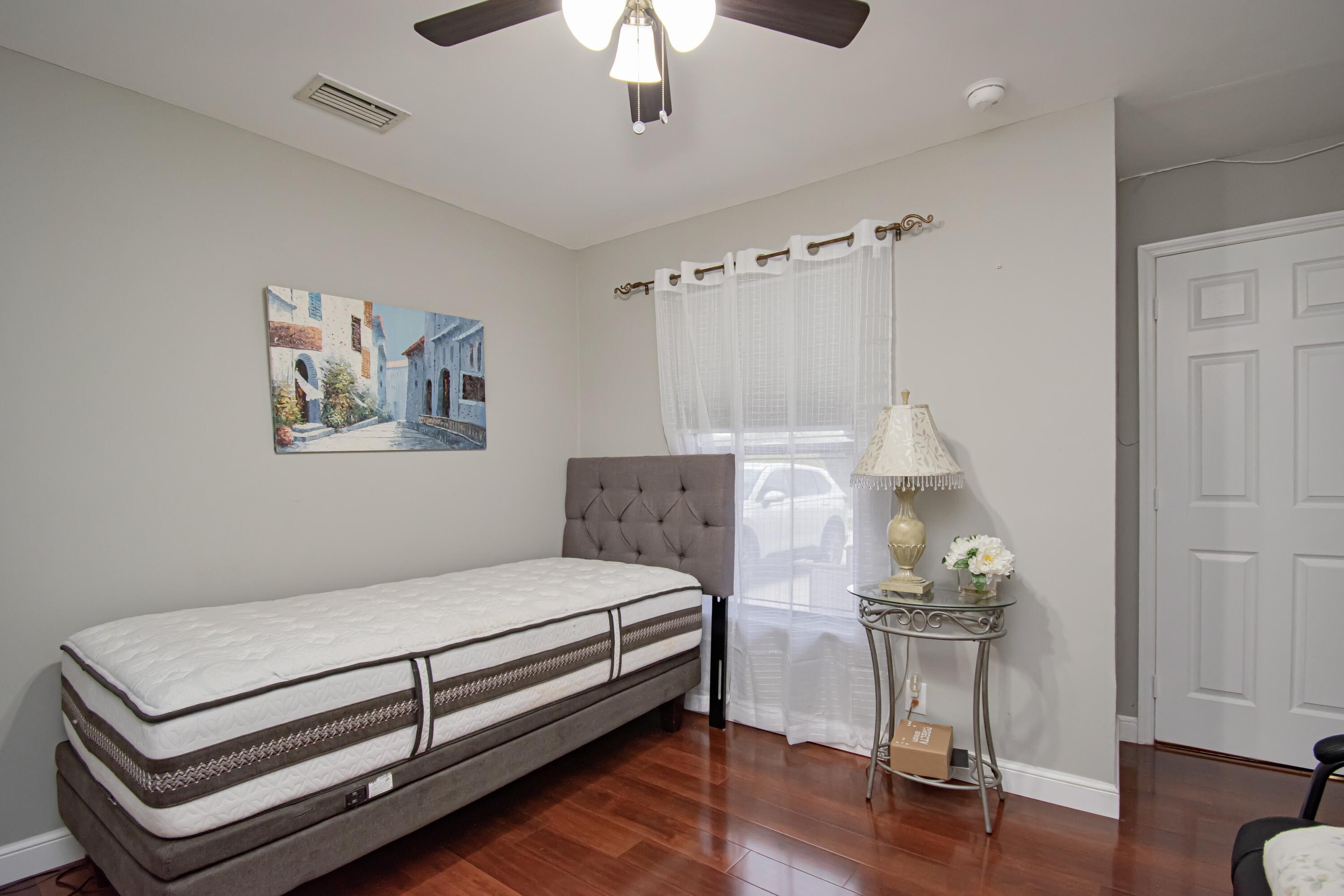 7838 Cypress Crescent Boca Raton, FL 33433 - Photo 21 of 24 a bedroom with a bed and a chair
