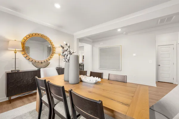 a view of kitchen with refrigerator dining table and chairs