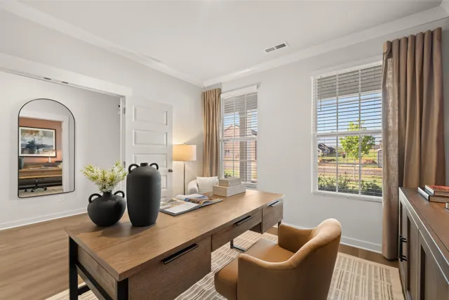 a kitchen with stainless steel appliances a dining table chairs microwave and refrigerator