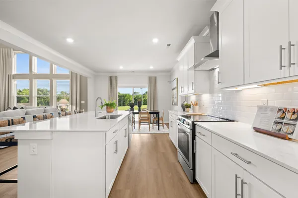a living room with furniture large window and a fireplace