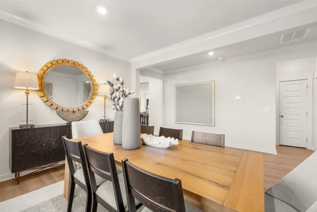 a view of a dining room with furniture and a potted plant