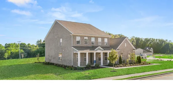 a front view of a house with a yard