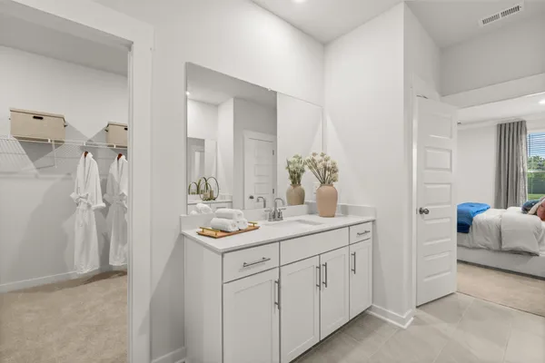 a bedroom with a bed and a lamp