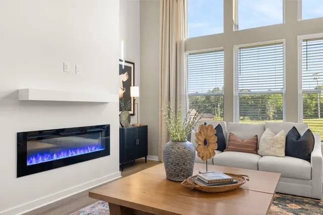 a living room with furniture and view of kitchen