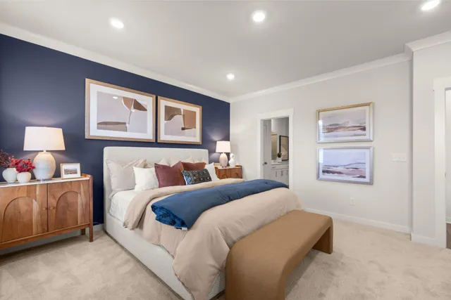 a bedroom with a bed and a flat tv screen on the dresser