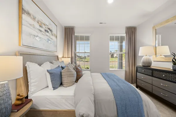 a bedroom with a bed and lamp