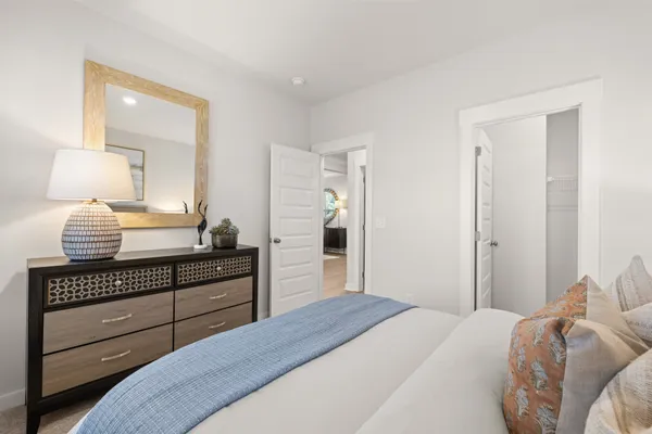 a bedroom with a bed and a dresser